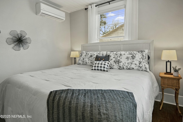 bedroom featuring dark hardwood / wood-style floors and a wall unit AC