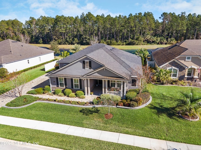 view of front of house featuring covered porch and a front yard