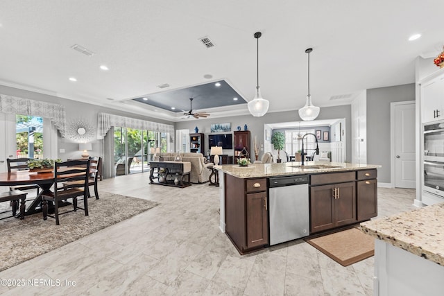 kitchen featuring a raised ceiling, sink, ceiling fan, appliances with stainless steel finishes, and dark brown cabinets