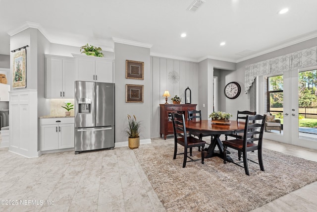 dining room with crown molding and french doors