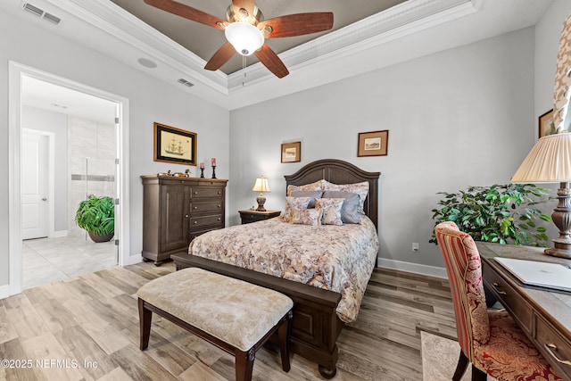 bedroom featuring a tray ceiling, ceiling fan, and crown molding