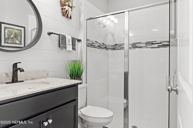 bathroom featuring vanity, toilet, and walk in shower