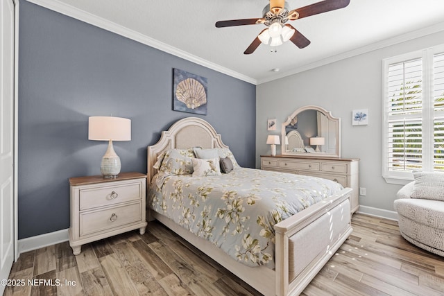 bedroom featuring ceiling fan, light wood-type flooring, and crown molding