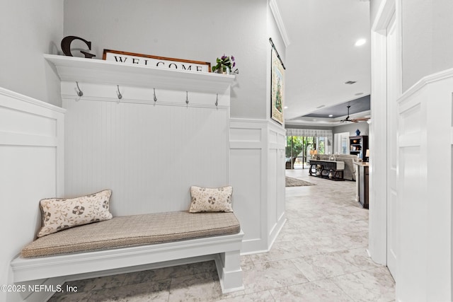 mudroom with ceiling fan and ornamental molding