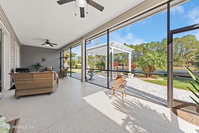 sunroom featuring ceiling fan