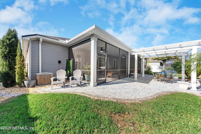 rear view of house with a sunroom, a yard, ceiling fan, a pergola, and a patio area