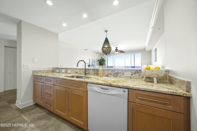 kitchen with sink, decorative light fixtures, white dishwasher, kitchen peninsula, and light stone countertops