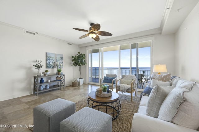 living room with ceiling fan and a water view