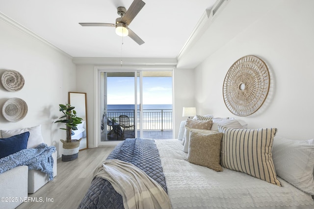 bedroom with a water view, light wood-type flooring, crown molding, and access to outside