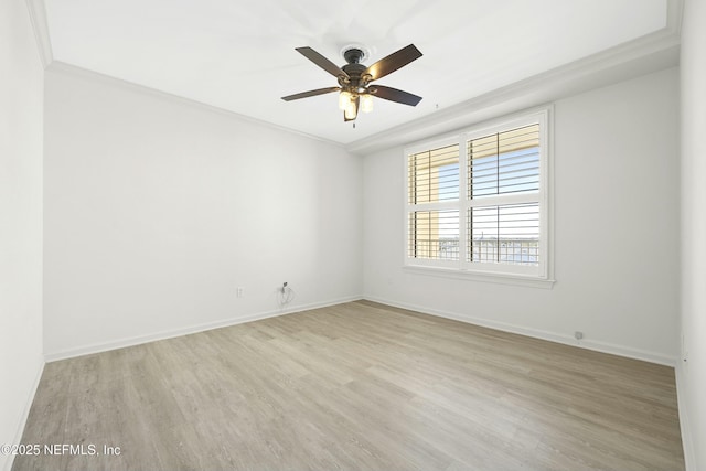 spare room featuring crown molding, light hardwood / wood-style floors, and ceiling fan