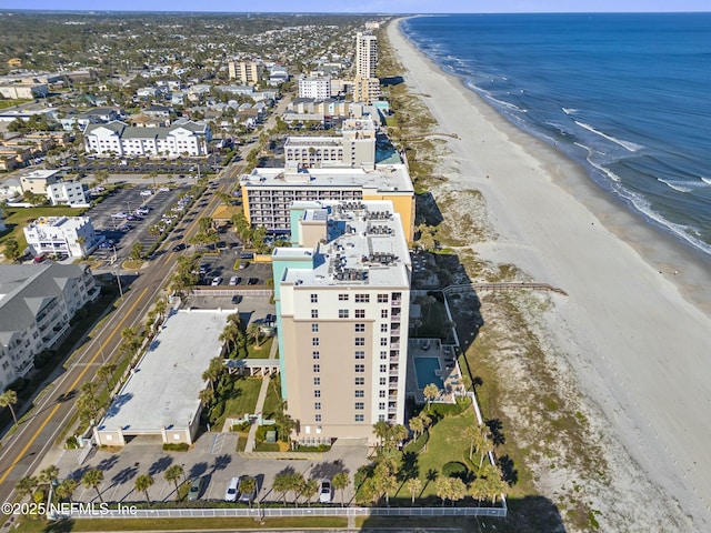 drone / aerial view featuring a water view and a view of the beach