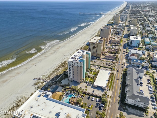 bird's eye view featuring a water view and a beach view