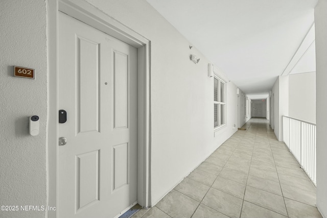 corridor with light tile patterned flooring