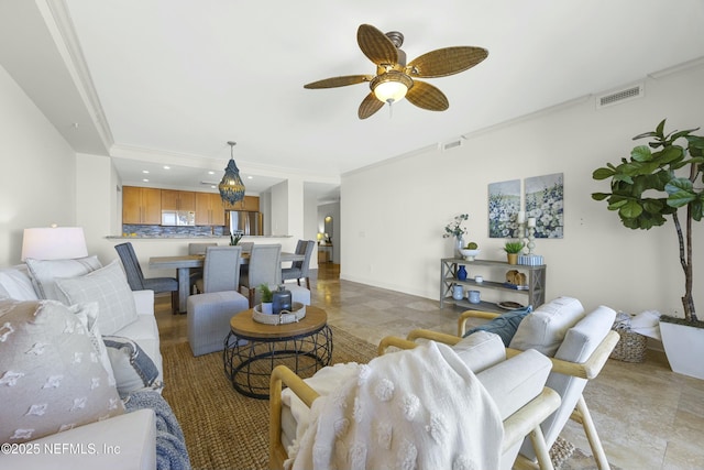 living room featuring ceiling fan and ornamental molding