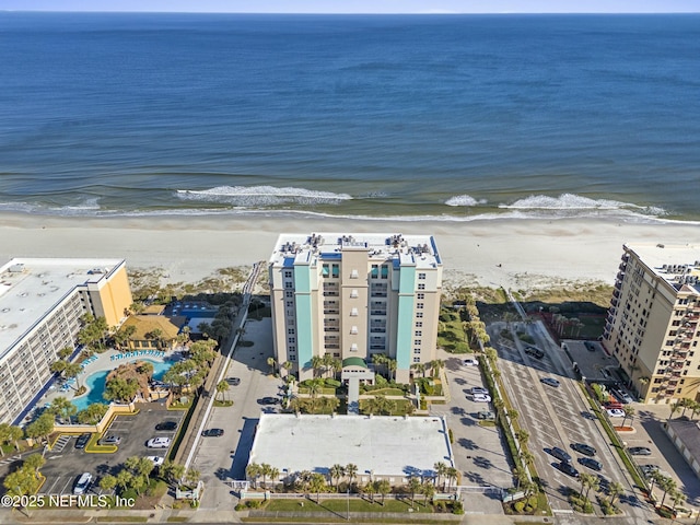 birds eye view of property with a water view and a view of the beach