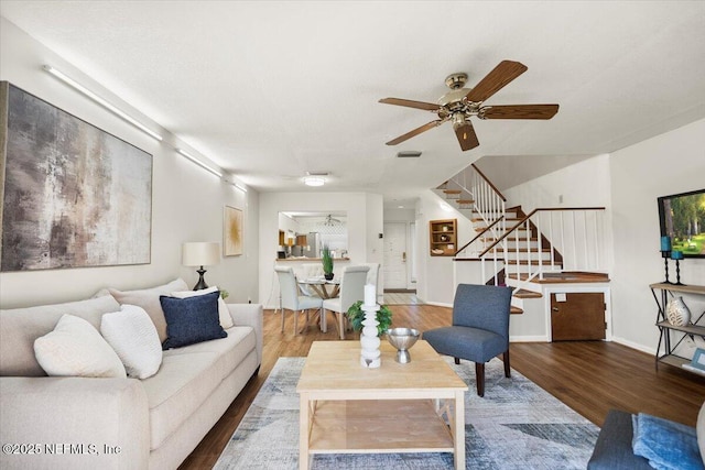 living room featuring ceiling fan and hardwood / wood-style flooring