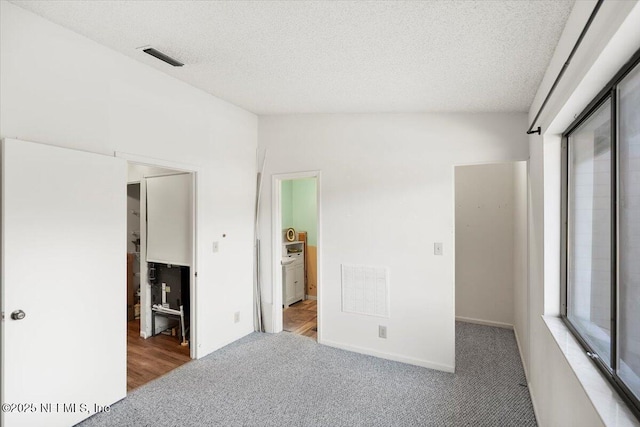 unfurnished bedroom featuring carpet floors and a textured ceiling