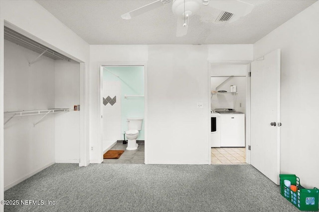 unfurnished bedroom featuring ceiling fan, a closet, light carpet, and washing machine and clothes dryer