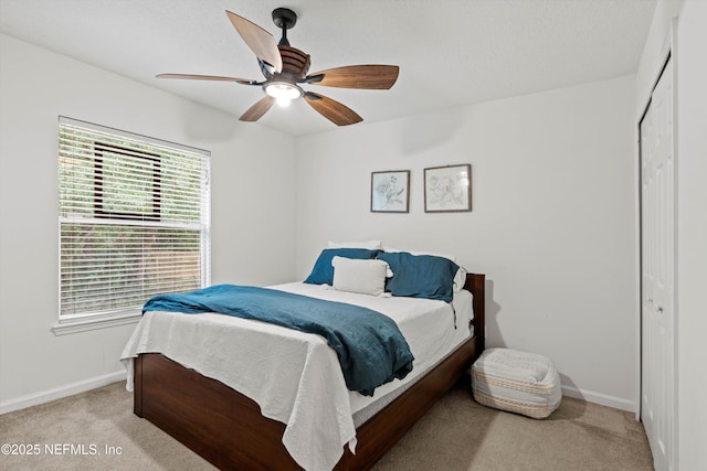 carpeted bedroom with a closet and ceiling fan