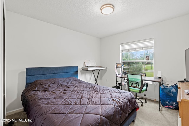 carpeted bedroom featuring a textured ceiling