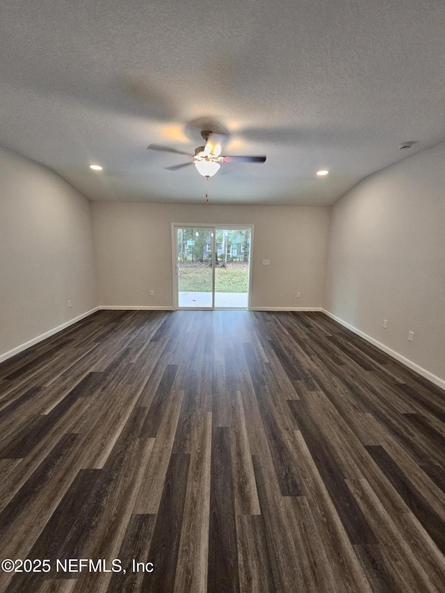 unfurnished room with ceiling fan, dark hardwood / wood-style flooring, and a textured ceiling