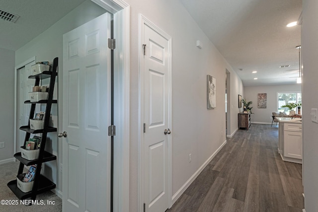 corridor featuring dark wood-type flooring