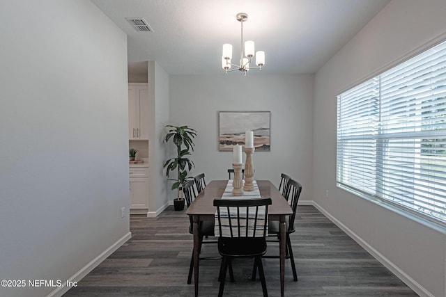 dining area featuring a chandelier and dark hardwood / wood-style floors