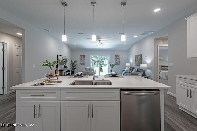 kitchen with white cabinets, sink, stainless steel dishwasher, ceiling fan, and decorative light fixtures