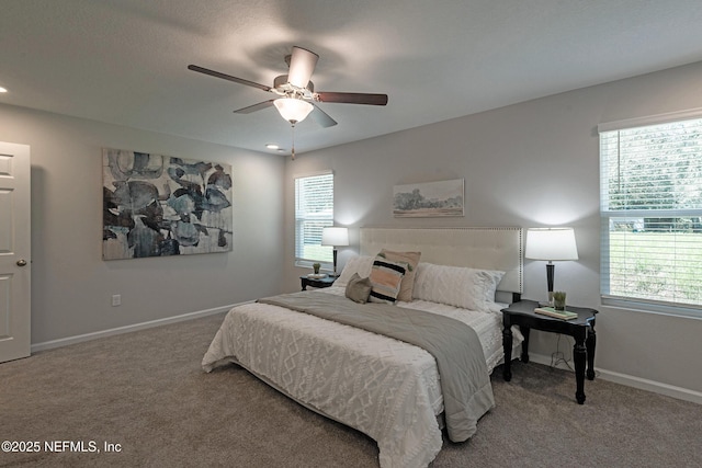 carpeted bedroom with ceiling fan and multiple windows