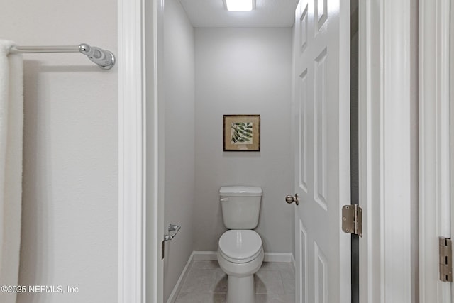 bathroom with tile patterned floors and toilet