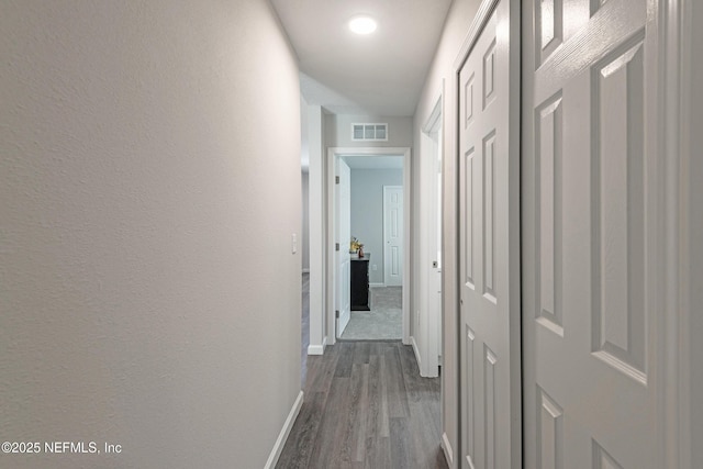 corridor featuring hardwood / wood-style floors