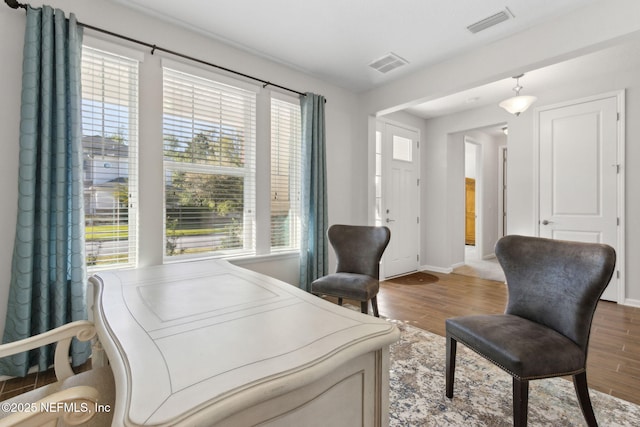 office area featuring plenty of natural light, visible vents, and wood finished floors