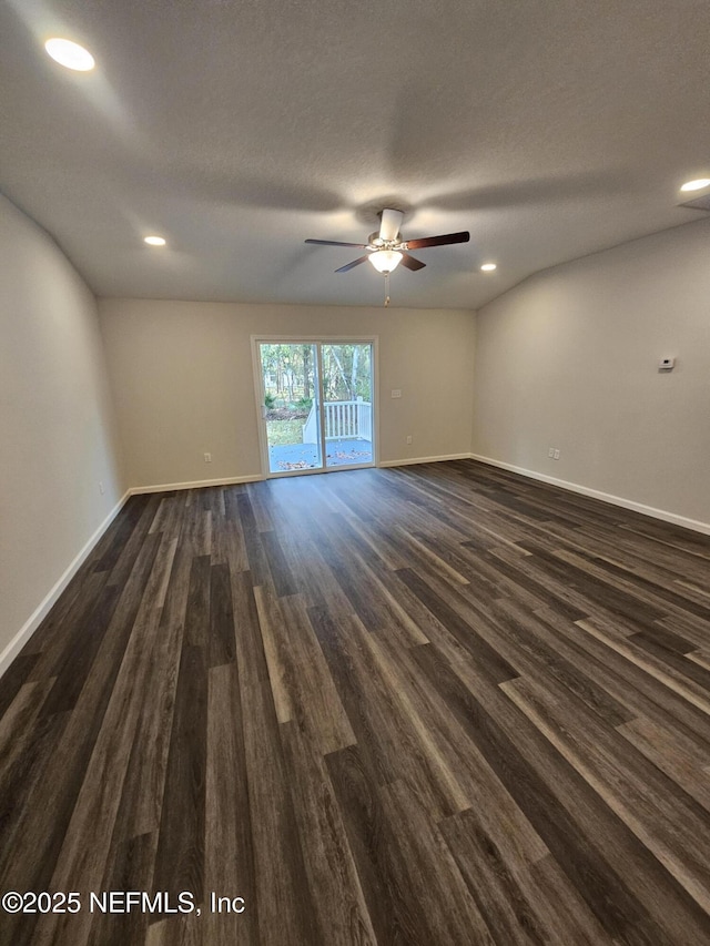 empty room with a textured ceiling, ceiling fan, and dark hardwood / wood-style floors