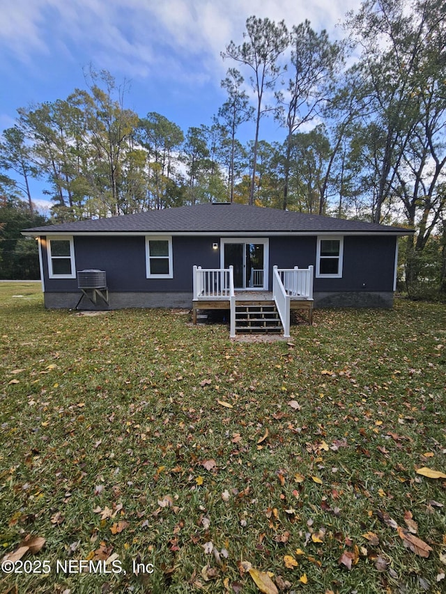 back of property with a lawn and a wooden deck