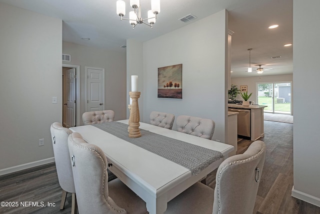 dining room featuring ceiling fan with notable chandelier and dark wood-type flooring