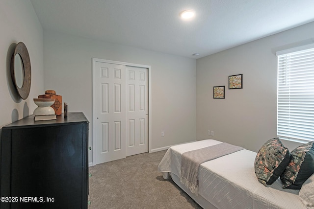 carpeted bedroom with a closet