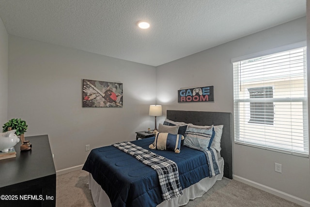 bedroom with carpet floors and a textured ceiling
