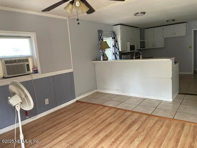 kitchen with light tile patterned floors, cooling unit, ceiling fan, and gray cabinetry