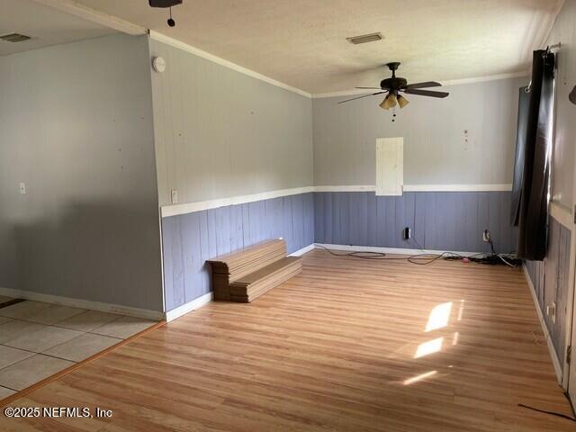 unfurnished room featuring tile patterned flooring, ceiling fan, and ornamental molding