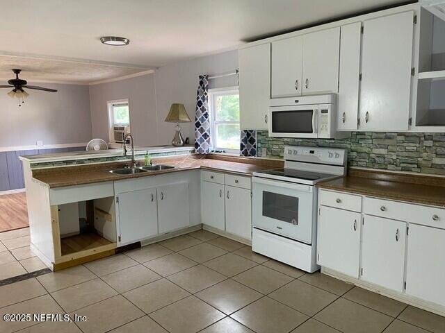 kitchen with tasteful backsplash, white appliances, ceiling fan, sink, and white cabinetry