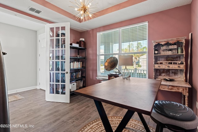 office space featuring a notable chandelier and wood-type flooring