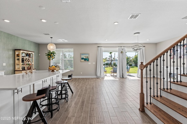 kitchen with a breakfast bar area and decorative light fixtures