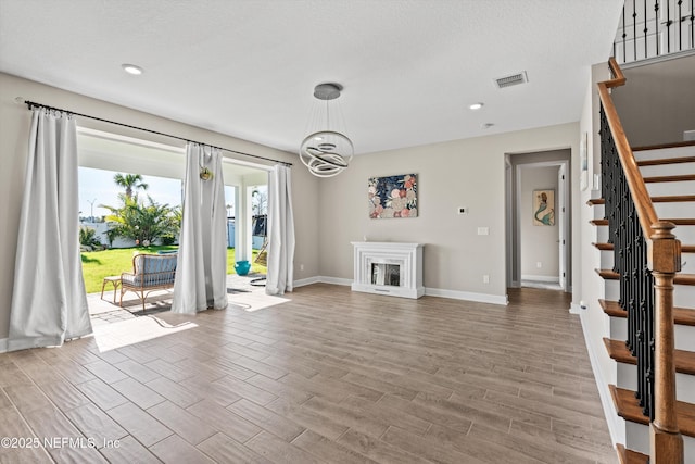 unfurnished living room with a chandelier