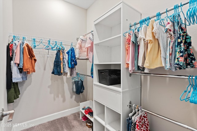 walk in closet featuring carpet