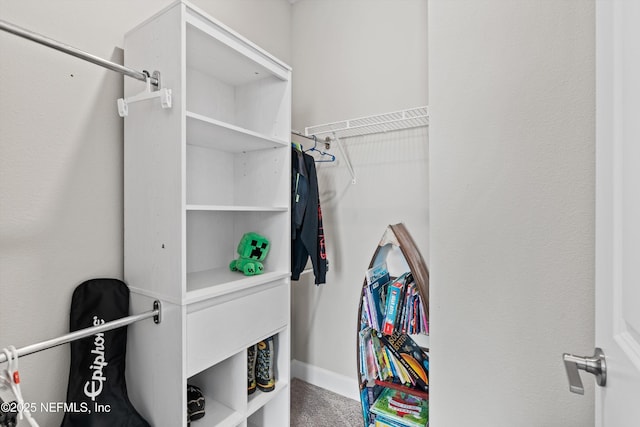 walk in closet featuring carpet flooring