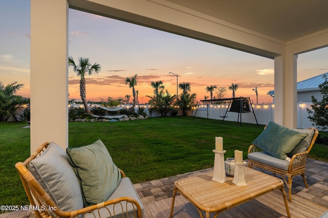 yard at dusk featuring a patio