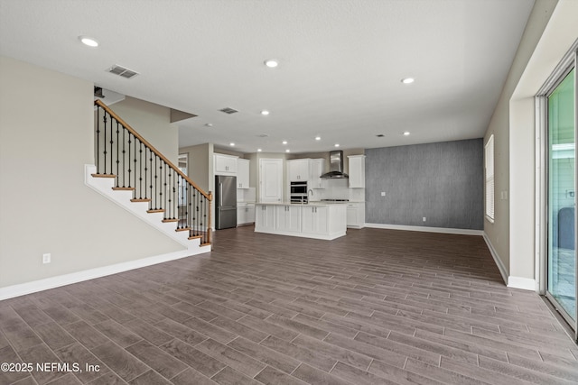 321 Marquesa Cir, Saint Johns, FL 32259 - unfurnished living room featuring baseboards, wood finished floors, recessed lighting, stairs, and plenty of natural light