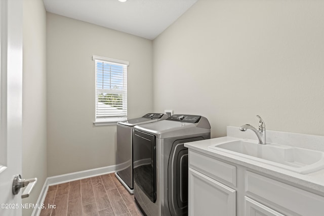 321 Marquesa Cir, Saint Johns, FL 32259 - clothes washing area featuring washer and clothes dryer, cabinet space, light wood-type flooring, and baseboards
