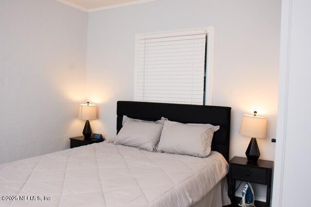 bedroom featuring crown molding