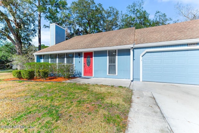 single story home featuring a garage and a front yard